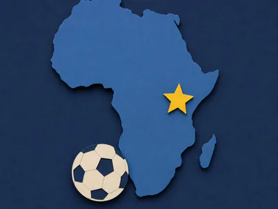 A paper-cut African continent beside a small paper football on navy